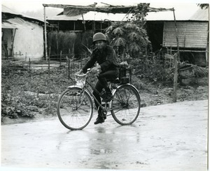 Soldier biking through the rain