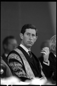 Prince Charles in academic robes, seated, at the 350th anniversary celebration of Harvard University