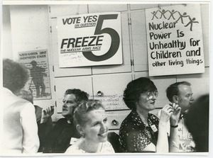 Nuclear Freeze rally at the Edwards Church: attendees seated under signs promoting Proposition 5 and reading 'Nuclear power is unhealthy for children and other living things'