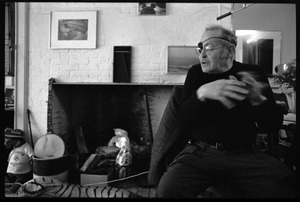 W. Eugene Smith, seated at a desk: view over stuffed toy tigers