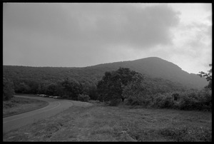 Stormy landscape with distant mountains, seen from the road