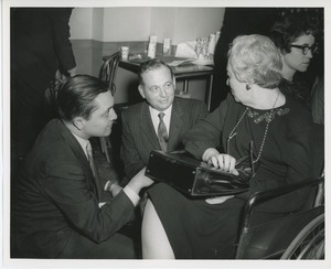 Woman in wheelchair and unidentified men at Thanksgiving celebration