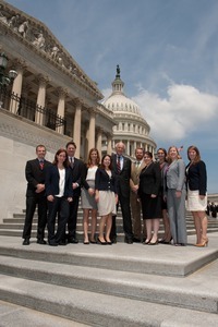 Congressman John W. Olver (center) with visiting group, posed on the steps of the United States Capitol building