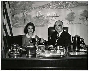 Unidentified woman and man holding silver bowl in Mayor Collins's office