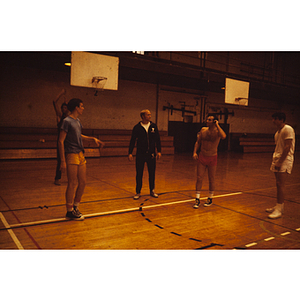 Young men standing on basketball court