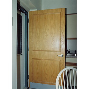 Door opening into a kitchen in a Villa Victoria housing unit.