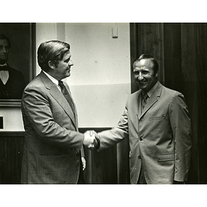 Frederick J. Davis, at left, shaking hands with John Whelam