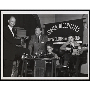 Community Campaign Chairman of the Boys' Club Buidling Fund David P. Goodwin (left) and Governor of New Hampshire Lane Dwinell (center) accompany two Bunker Hillbillies during the opening dinner of the Community Campaign at the Hotel Carpenter in Manchester, New Hampshire on May 21 1956