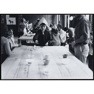 A plays a game at a party as two girls and a man look on