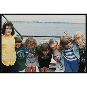 Seven girls pose for a candid shot the deck of a boat