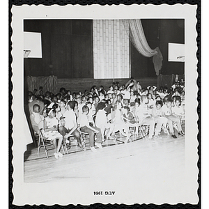 Participants sitting in an auditorium with their brothers at a Boys' Club Little Sister Contest