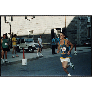 A teenage boy runs in the Battle of Bunker Hill Road Race