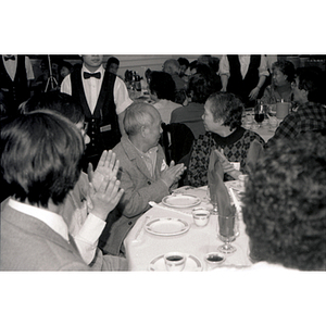 Guests applauding at a Chinese Progressive Association party