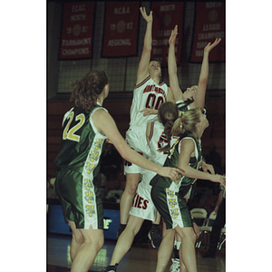 Northeastern women's basketball players jumping to steal ball