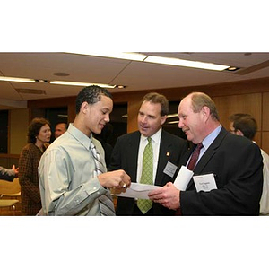 Odalis David Polanco receives an envelope from Ted English at the Torch Scholars dinner