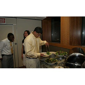 Danny Vazquez fills up his plate at the Torch Scholars dinner