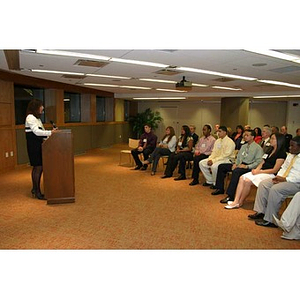 The audience watches Philomena Mantella at the podium