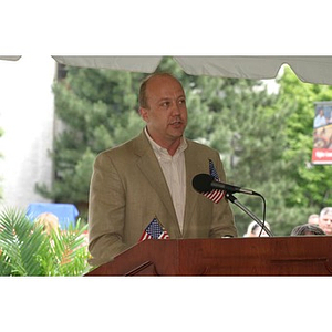 A man with a flag in his pocket speaks at the Veterans Memorial groundbreaking ceremony