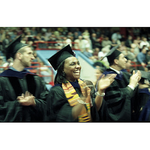 A School of law graduate clapping during her graduation ceremony