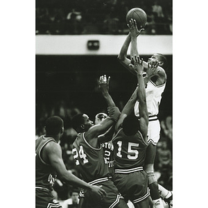 Reggie Lewis looms high for a shot over 4/5 of the BU basketball team