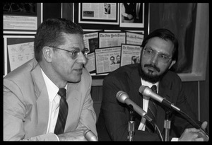 Joseph H. Taylor (left, speaking) and Russell A. Hulse: seated at a microphone at a press conference at UMass Amherst following receipt of the Nobel Prize in Physics