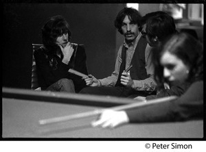 Woman shooting pool: Graham Nash is being interviewed by Elliot Blinder in the background