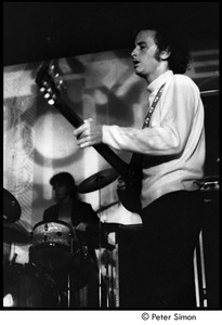 The Doors at the Crosstown Bus: Robby Krieger (guitar) with John Densmore (drums) in the background