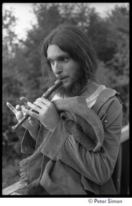 Long-haired man playing a recorder, Rowe Center spiritual retreat