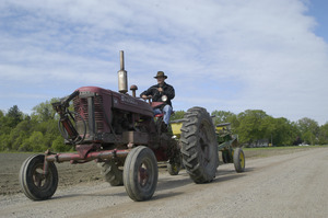 Lazy Acres Farm (Zuchowski Farm): Allan Zuchowski riding a Farmall tractor