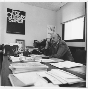 Jay Savereid, seated, on phone, at desk