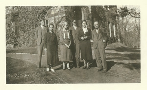 Library staff standing southeast of ivy covered Old Chapel building