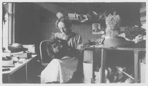 Unidentified woman working in hat shop