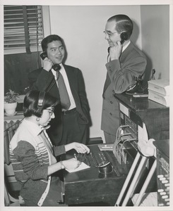 Barbara Sasso demonstrating her proficiency at switchboard operation for two onlookers