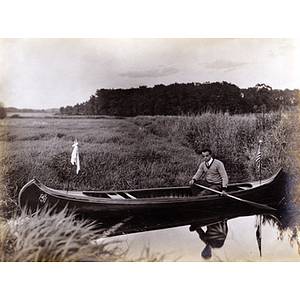 Charles H. Bruce posed in a canoe