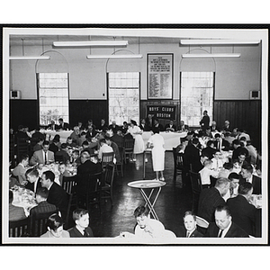 Boys and men sit around tables and eat during a Boys' Clubs of Boston awards event