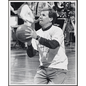 Boston sportscaster Gary Gillis shooting a basketball at a fund-raising event held by the Boys and Girls Clubs of Boston and Boston Celtics