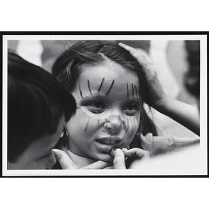 A young girl having her face painted during a Boys' Clubs of Boston event