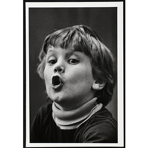 A boy from the Boys' Clubs of Boston looking off with his mouth open
