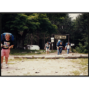 A group of youth with backpacks exit the Piper Trail