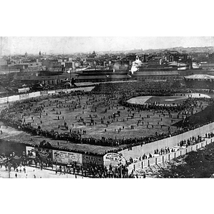 People crowd the field at the first World Series baseball game at the old Huntington Avenue Baseball Grounds