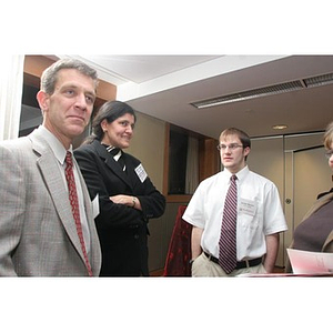 Jordan Munson stands with two people at a Torch Scholars event