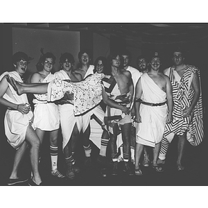 Students dressed in togas pose together