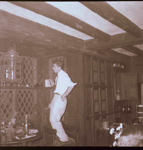 Man standing on a chair, looking out of window, Beauport, Sleeper-McCann House, Linebrook Parish Room, Gloucester, Mass.