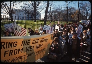 Antiwar protesters march past the white house with a banner reading 'Bring the GIs home from Viet Name' and signs reading 'Honor peace': Washington Vietnam March for Peace