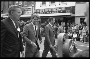 Robert F. Kennedy and entourage walking past Landers Ladies Apparel, during the Turkey Day festivities