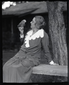 Tryphena M. Clark with pet bird Lori-Bird on her finger
