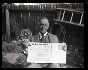 Henry A. Ellis and the doughnut: Ellis seated with oversized donut and a "Do-nut post card"