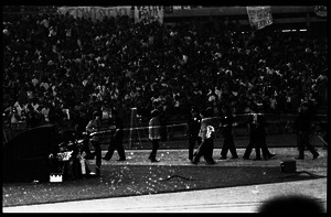 Beatles concert at Shea Stadium: Beatles walking toward the stage with crowd in background: George Harrison, John Lennon, and Paul McCartney (l. to r.)
