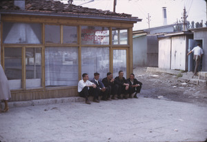 Men chatting outside Carsija shop