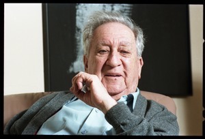 Fine art photographer Aaron Siskind: close-up portrait, seated in a armchair in his living room